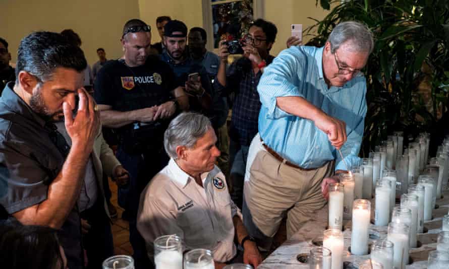 The El Paso mayor, Dee Margo, right, lights candles after the shooting, with Greg Abbot, the Texas governor.