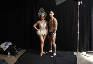 Tattoo enthusiasts pose for photographs during the London Tattoo Convention at Tobacco Dock