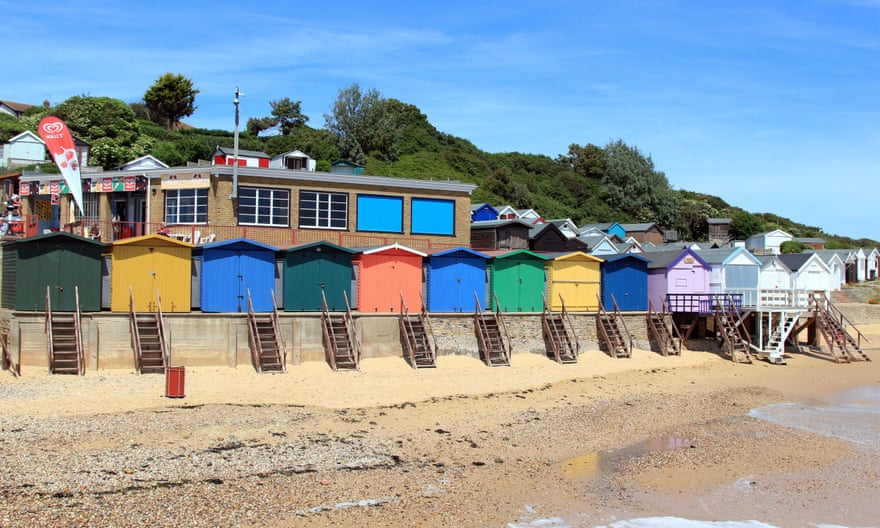Beach huts on the seafront at Walton on the Naze, Essex, and Hipkins Cafe/tea room