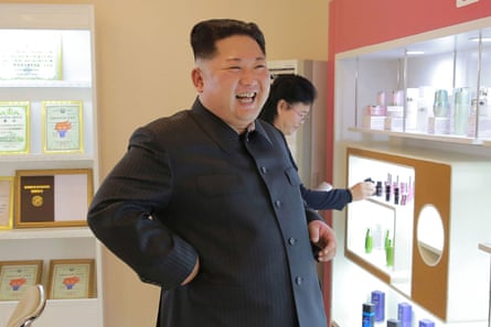 The North Korean leader looks at products in the cosmetics factory.