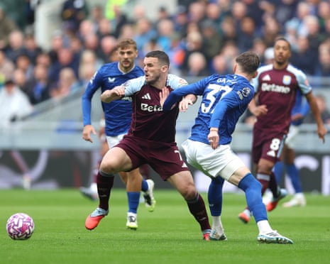 John McGinn of Aston Villa is challenged by James Garner of Everton.