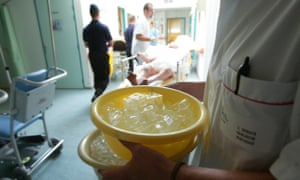 A doctor carries ice cubes to help cool down a patient suffering from hyperthermia, during the Paris heatwave of August 2003