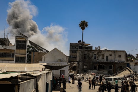 Smoke rises after an Israeli attack hit a house of a Palestinian family near al-Ahly hospital in Gaza City on Saturday.