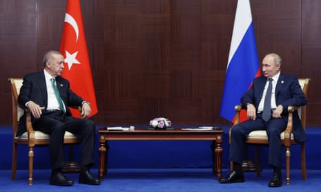 Erdoğan and Putin talk to each other during their meeting on sidelines of the summit.