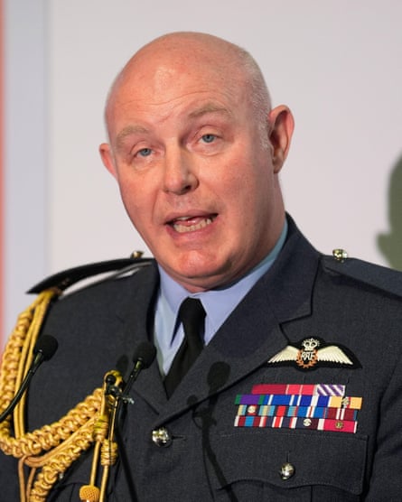 Harv Smyth speaks into a microphone while wearing his military uniform