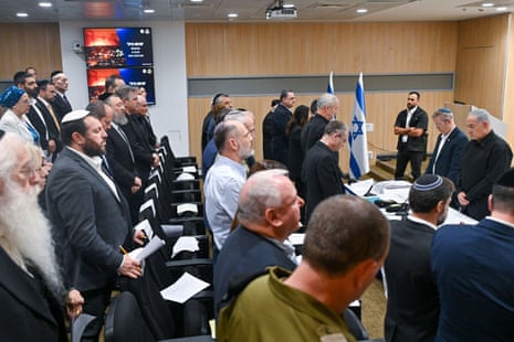 A moment of silence at the first cabinet meeting of Israel’s national emergency government.