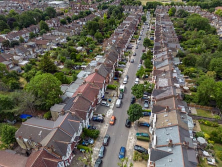 aerial view of two streets of suburban residential properties in Enfield; they are terraces with gardens behind and cars parked in front.