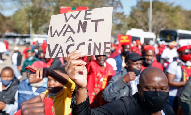 A member of the leftwing Economic Freedom Fighters (EFF) party holds a sign calling for Covid vaccines to be sent to Africa