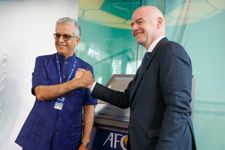 Sheikh Salman and Gianni Infantino clasp hands.