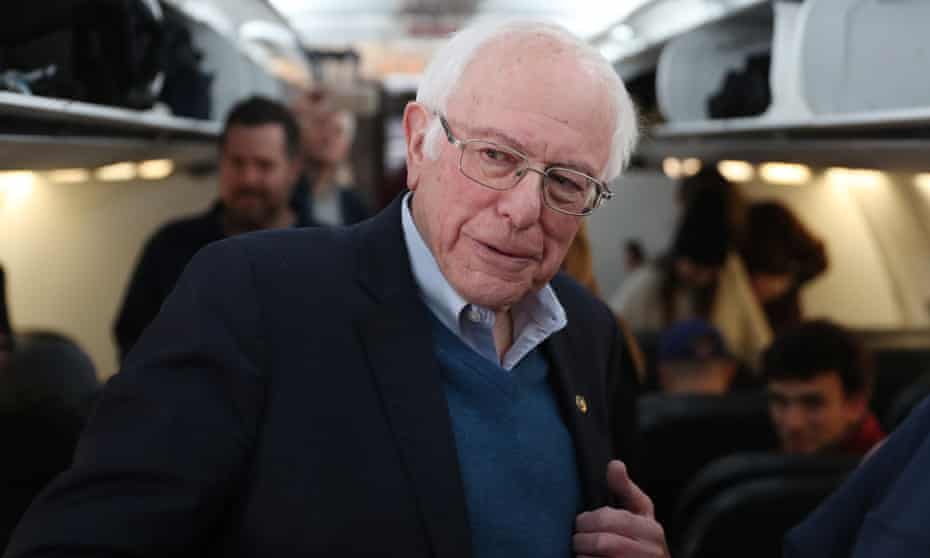 Senator Bernie Sanders speaks to the media after boarding the plane at the Des Moines international airport en route from Iowa to New Hampshire.