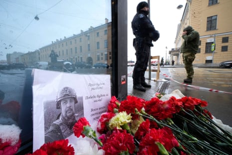Flowers and a poster with a photo of blogger Vladlen Tatarsky placed near the site of an explosion at the “Street Bar” cafe in St Petersburg, Russia,
