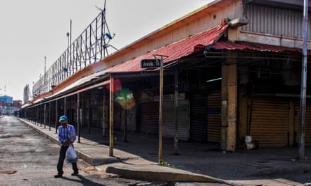 A man walks outside the empty flea market in Maracaibo on 2 July.