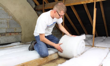Man laying loft insulation in attic