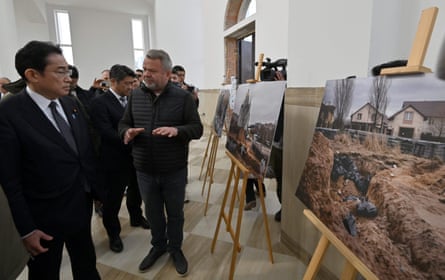 Japan’s prime minister Fumio Kishida visits a photo exhibition showing images of the site of a mass grave found in Bucha, Ukraine