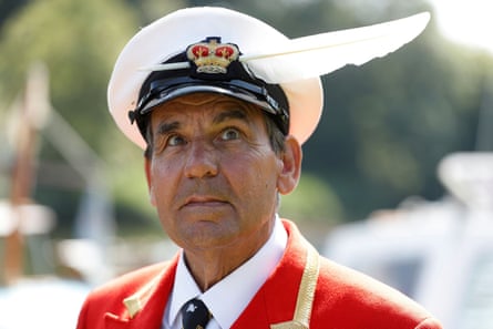 A man in uniform wears a swan feather in his hat