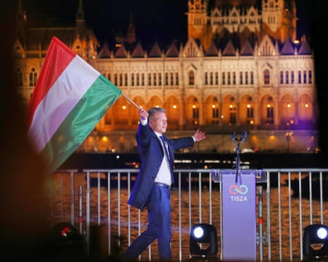 Péter Magyar waves a Hungarian flag at a TISZA election party at night in Budapest