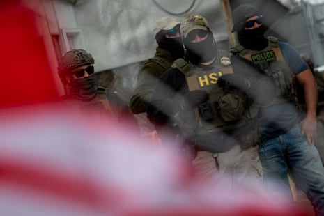 Masked men in camouflage and bulletproof vests.