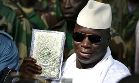 The former president Yahya Jammeh holds up a Qur’an in Banjul in 2006.