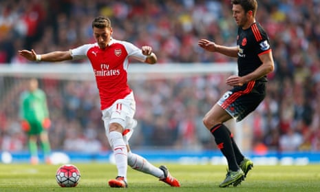 Mesut Özil, left, keeps Michael Carrick of Manchester United at bay during Arsenal’s 3-0 win at the Emirates.