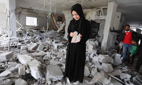 Palestinians inspect the remains of a building following an Israeli airstrike, in the Gaza Strip, this week. 