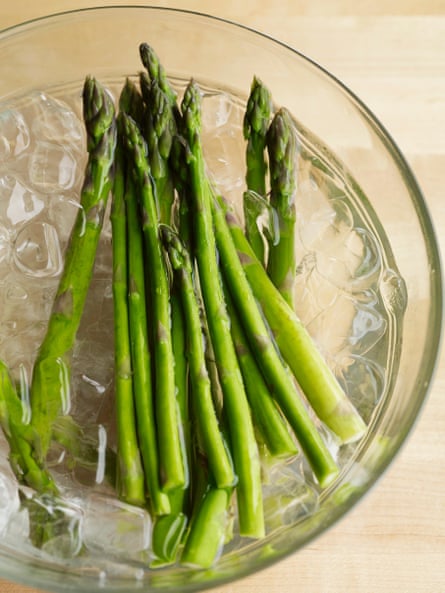 Asparagus soaking in iced water before cooking