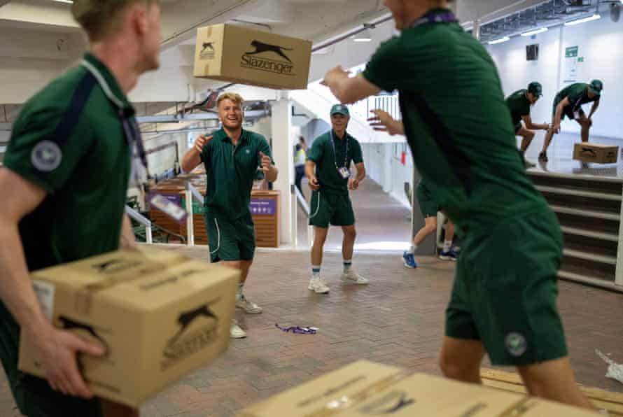 Court Attendants work together to unload boxes of tennis balls underneath Centre Court.