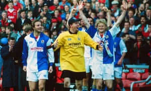 Tim Flowers leads the celebrations as Tim Sherwood and Colin Hendy re-emerge for the presentation ceremony at Anfield.