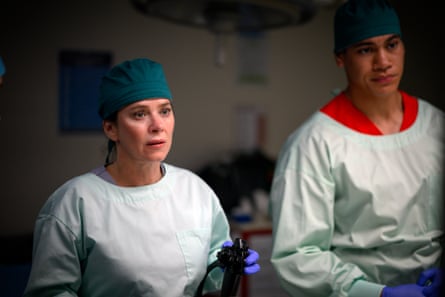Anna Friel and Ioane Sa’ula in scrubs for surgery