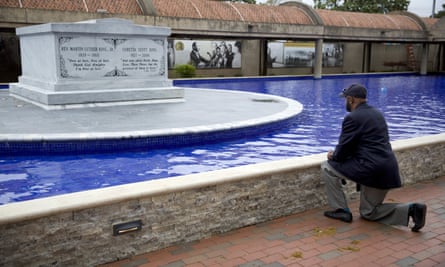 Jeremiah Bridgewater kneels at the gravesite of the Martin Luther King in Atlanta on Wednesday.