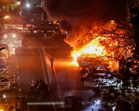 Cars burn in a Tehran street during the January protests