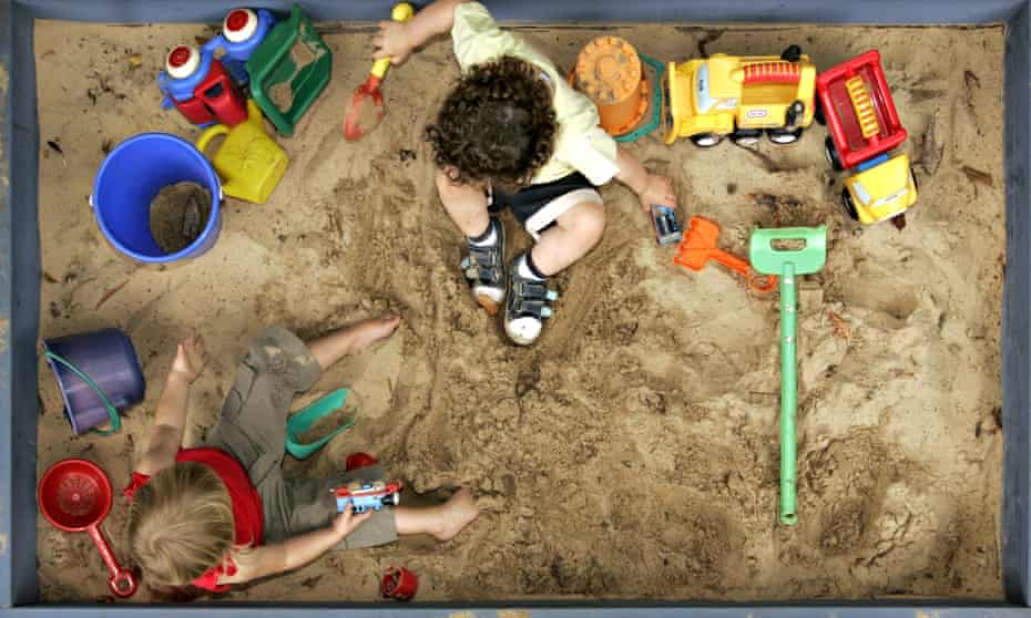 Children play with colourful toys in a sandbox