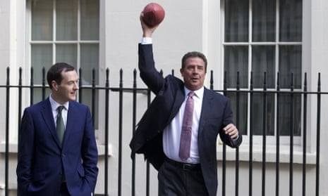 George Osborne watches as Miami Dolphins legend Dan Marino throws an American football in Downing Street.