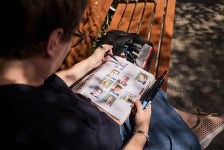 Liz Steel sits on a bench while sketching