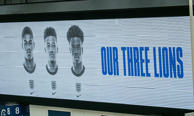 The pictures of England players Marcus Rashford, Jadon Sancho and Bukayo Saka on an electronic board above the concourse at Waterloo station in London.