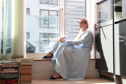 Clare Jones sat on a window ledge in her flat