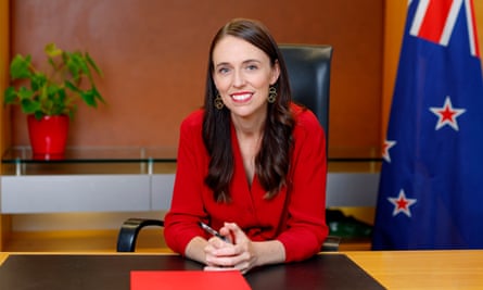 Jacinda Ardern poses at her desk for the last time as prime minister of New Zealand