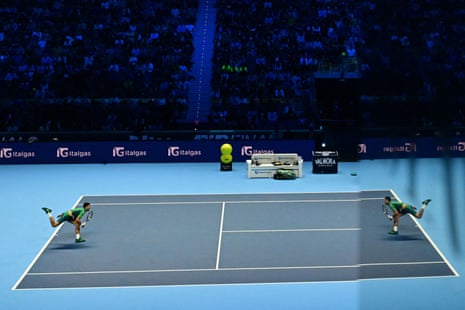 Novak Djokovic reflects himself in a window glass as he serves to Hubert Hurkacz during the final set.