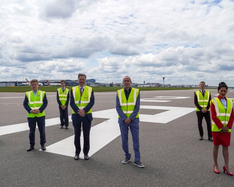 airline bosses and staff standing on a closed runway at heathrow airport