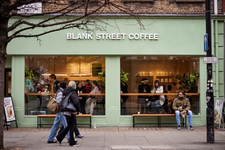 People walk by a plainly decorated coffee shop
