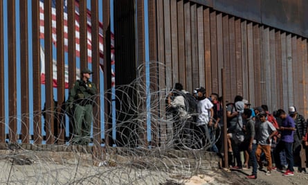 People from Central America at the US border fence in Tijuana, Mexico.