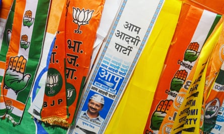 Scarves of different colours with words in Hindi script and symbols such as lotus flowers and hands, representing parties such as the BJP and Congress.