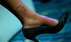 A map of Africa is seen tattooed on the ankle of a woman wearing stiletto heels