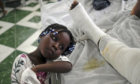 Younaika rests next to her mother, Jertha Ylet, who was injured in the earthquake, in hospital in Haiti