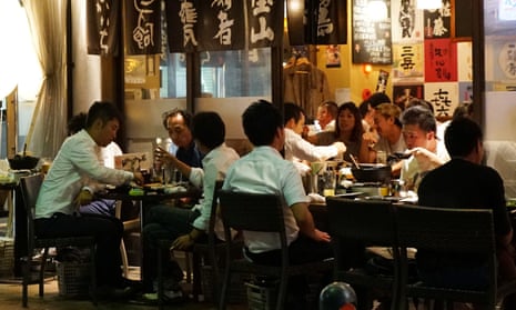 Japanese businessmen enjoying a drinking party at an "izakaya" pub