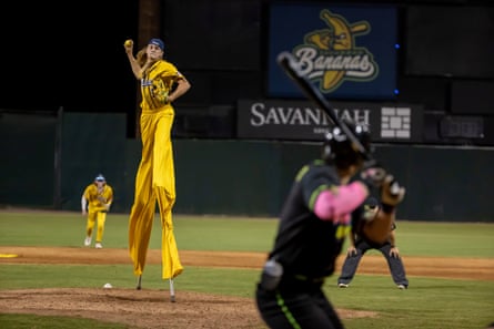 Dakota ‘Stilts’ Albritton of the Savannah Bananas pitches against the Party Animals at Grayson Stadium in May. Albritton plays the field, bats, and he pitches all while wearing a pair of stilts.