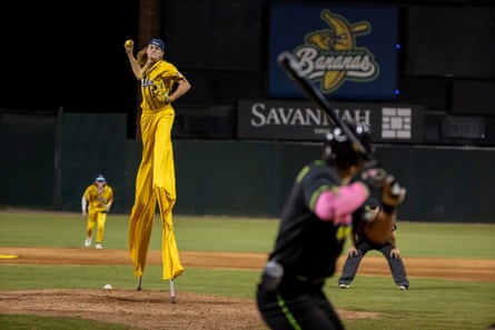 Dakota 'Stilts' Albritton of the Savannah Bananas pitches against the Party Animals at Grayson Stadium in May. Albritton plays the field, batting and throwing while wearing a pair of stilts.