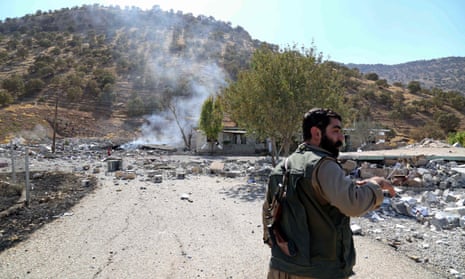A Kurdish fighter inspecting the damage after an Iranian cross-border attack in Zargwez, northern Iraq.