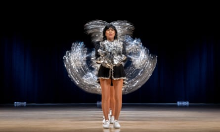 Rosemary Tiffany, 72, performs in the front of a line of members of the Sun City Poms as they all move their pom poms in sequence at a dress rehearsal on stage in Arizona, March 2023