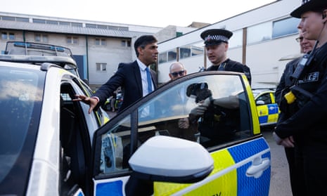 British prime minister Rishi Sunak is shown a new electric hybrid deployment police car during a media visit to Harlow police station in Essex.