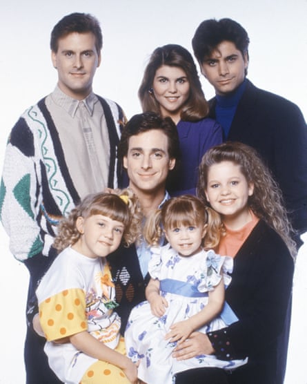 The cast of Full House in 1989: David Coulier, Jodie Sweetin, Saget (centre), Lori Loughlin, Mary-Kate Olsen, John Stamos and Candace Cameron.
